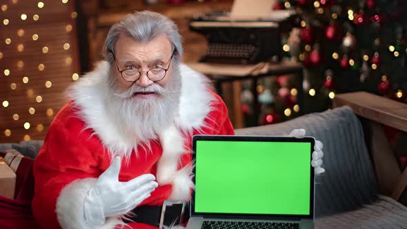 Portrait Elderly Man in Santa Claus Costume Holding Laptop Green Screen