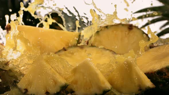 Slow Motion Shot of Pineapple and Juice Splashing Through Pineapple Slices