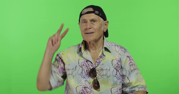 Senior Man Tourist in Colorful Shirt Dances. Handsome Old Man on Chroma Key
