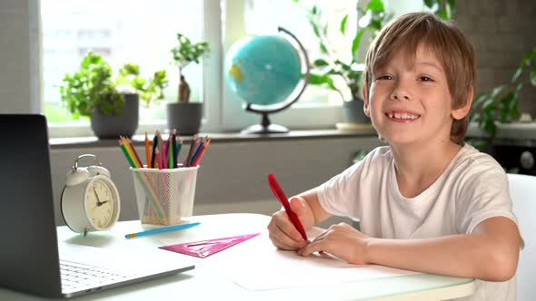 Happy Child Doing Homework at Home Smiles and Laughs