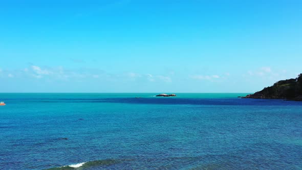 Tranquil bay with blue turquoise shallow lagoon washing cliffs and rocky coastline of tropical islan