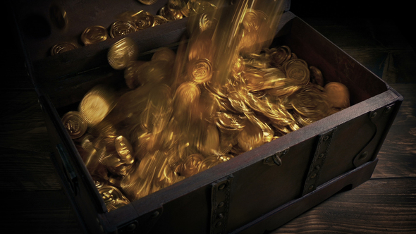 Gold Coins Are Poured Into Old Wood Chest