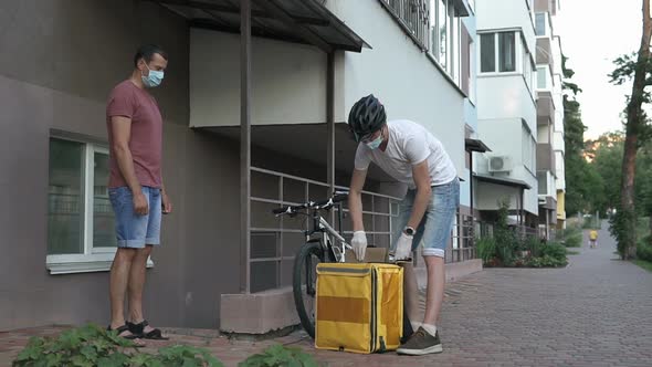 Home delivery service on a bicycle in a yellow thermo backpack