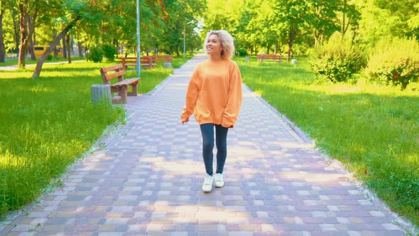 Teenager Walks in Summer Park