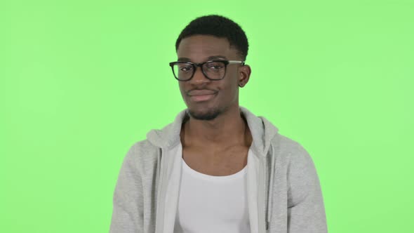 African Man Showing No Sign By Shaking Head on Green Background
