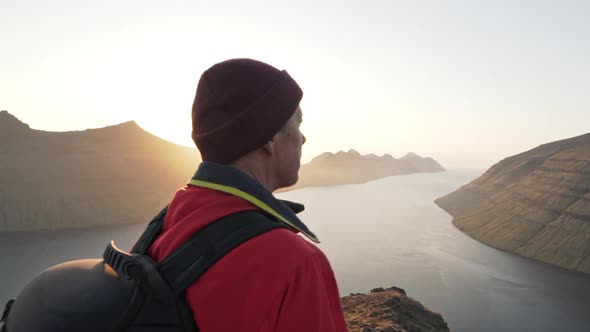 Hiker In Awe At Sunrise Over Mountains And Sea View