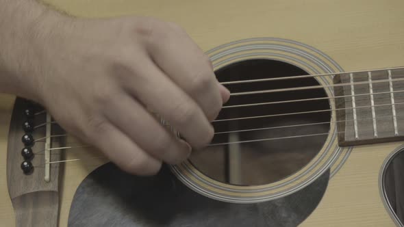 Hand playing the guitar in a music studio