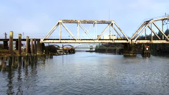 Large steel pivot railroad bridge spanning the Umpqua River bay near Reedsport Oregon