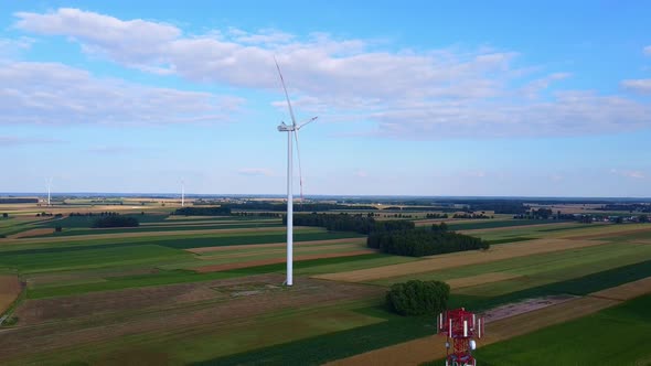 Aerial View of 5G Tower and Wind Energy Turbines in Summer