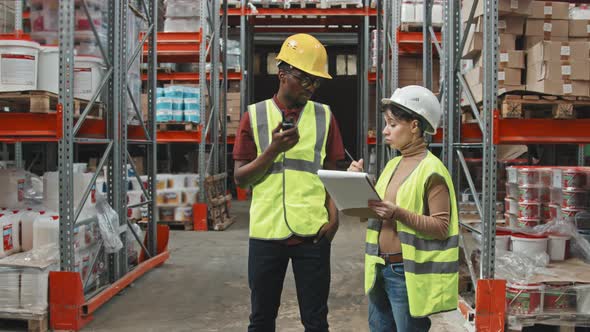 Warehouse Workers Having Conversation at Work