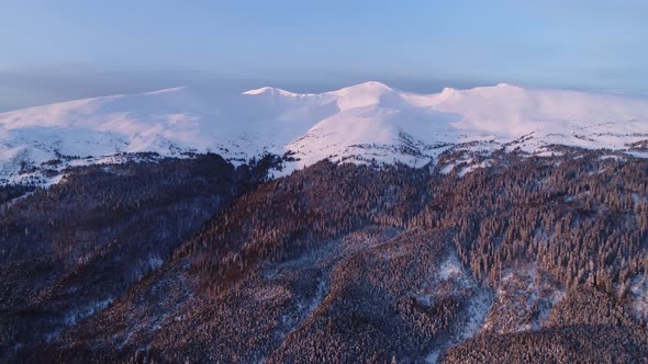 Aerial view in sunrise winter mountain