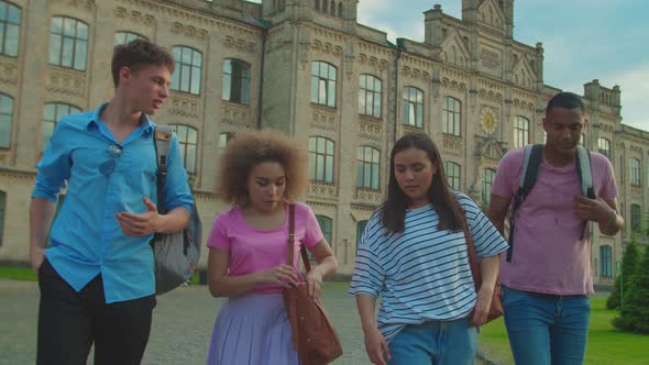 Multiracial Students Getting Notification with Exam Results Outdoors