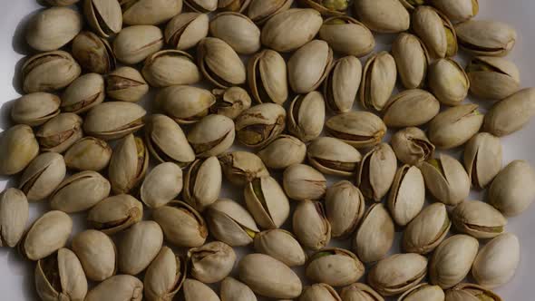 Cinematic, rotating shot of pistachios on a white surface - PISTACHIOS 004