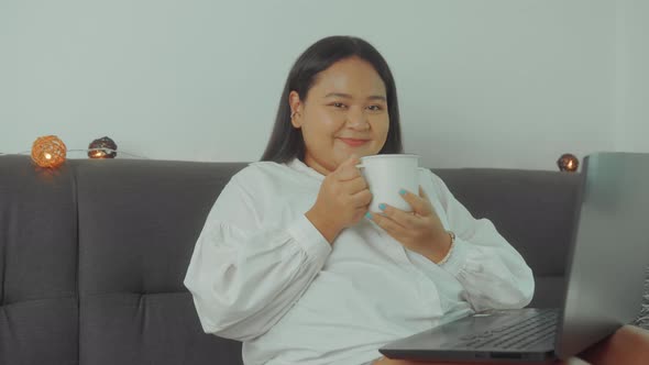 Asian Plus Size Woman Working Online with Laptop at Home Closeup Shot