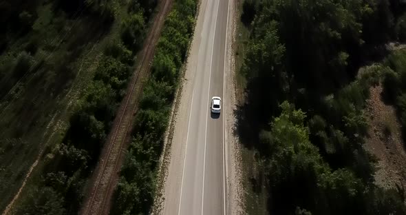 Aerial POV View Flying Over Forest Road with Cars