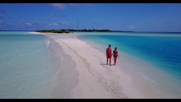 Family of two tan on paradise resort beach voyage by blue sea and white sandy background of the Mald