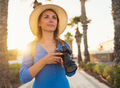Photographer tourist woman taking photos with camera in a beautiful tropical landscape at sunset - PhotoDune Item for Sale