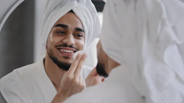 Funny Millennial Handsome Man Bearded Indian Arab Guy with White Bath Towel on Head Looks Into