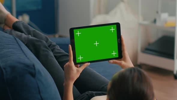 Close Up of Woman Looking at Tablet Computer in Horizontal Mode