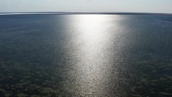 Top view of the sea. The rays of the sun are reflected in the sea water.