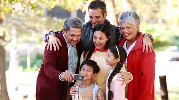 Multi-generation family taking a selfie in the park