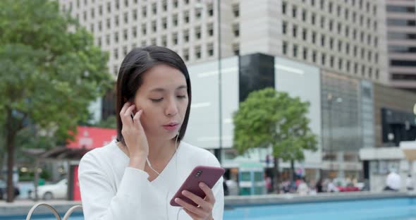 Woman look at mobile phone in Hong Kong