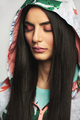 Young woman wearing hood standing with eyes closed - PhotoDune Item for Sale