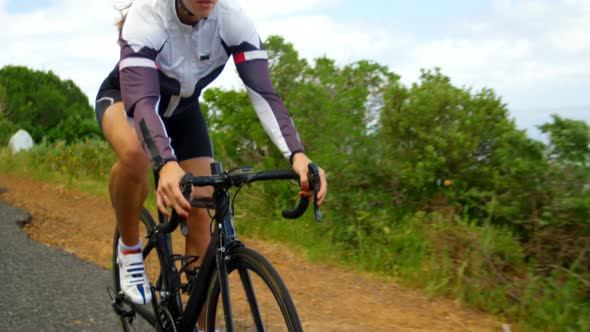 Female cyclist cycling on a countryside road