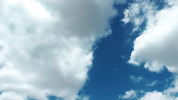 White Cumulus Rain Clouds Spreading Slowly Below The Blue Sky - Timelapse - Time Lapse