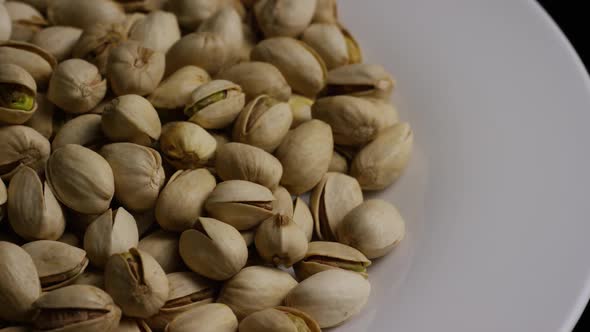 Cinematic, rotating shot of pistachios on a white surface - PISTACHIOS 035