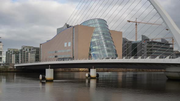 Time lapse of daytime road traffic and people walking by on Samuel Beckett bridge in Dublin City in alt