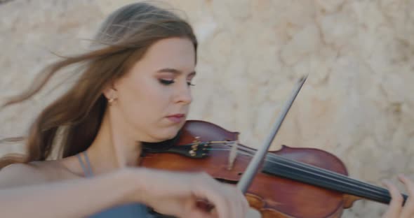 Female Musicians in Dresses Play Viola Take Turns on Camera at Cliff in Summer