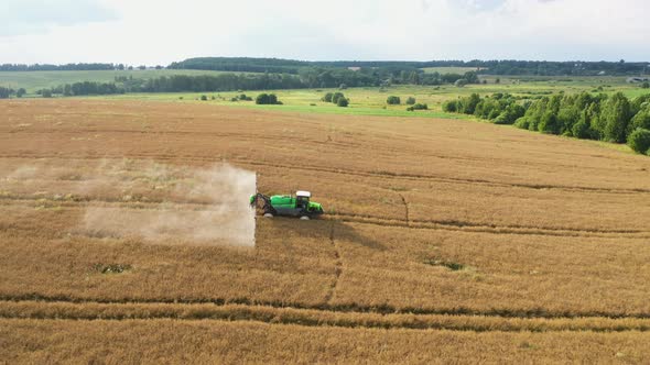 Aerial Farming Tractor Spraying On Rapeseed Field With Sprayer Growth Chemicals