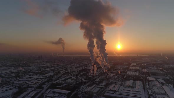 Aerial view of Smoke comes from the pipes of the factory at sunset 05