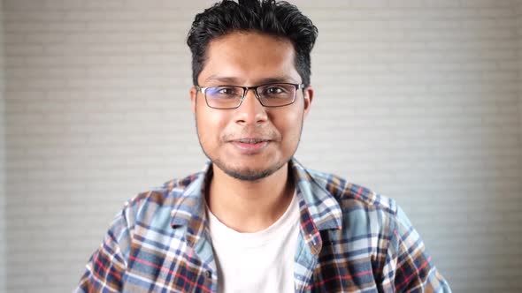 Happy Young Man Talking to a Camera in Video Conference