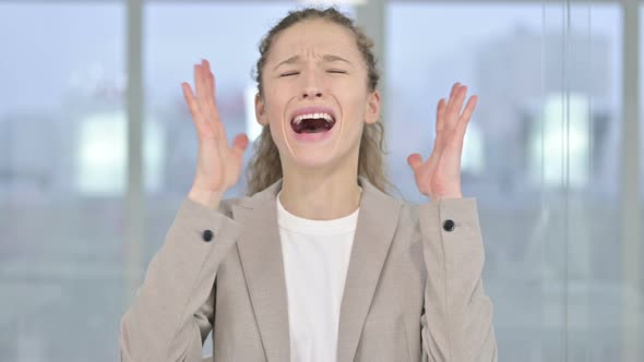 Portrait of Angry Young Businesswoman Shouting and Screaming