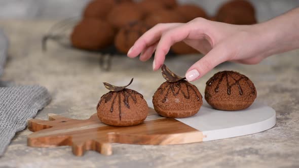 Decorating Choux Au Craquelin with Chocolate. Delicious French Dessert.