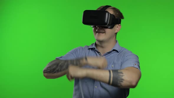 Man Using VR App Helmet To Play Simulation Game, Drawing. Guy Watching Virtual Reality 3d Video