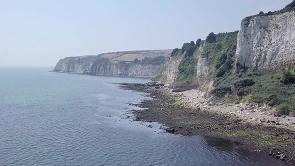 Aerial riseement over water, revealing the Seaton Beach