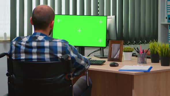 Disabled Freelancer Looking at Pc with Green Screen