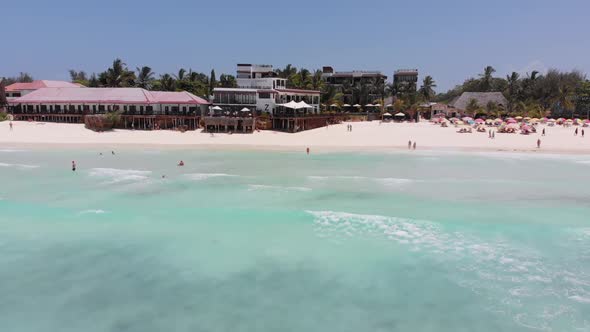 Tropical Sandy Beach with Clear Ocean Tidal Waves and Hotels Zanzibar Aerial