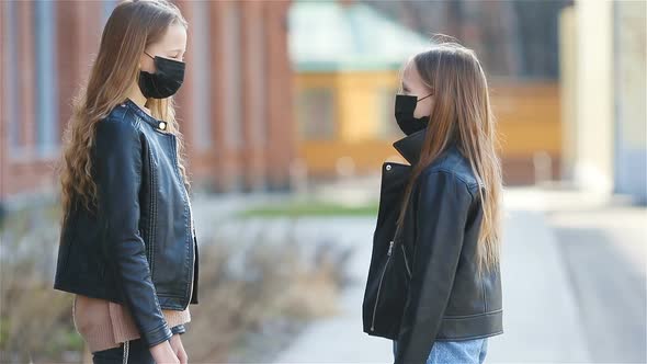 Girls Wearing a Mask on a Background of a Modern Building,