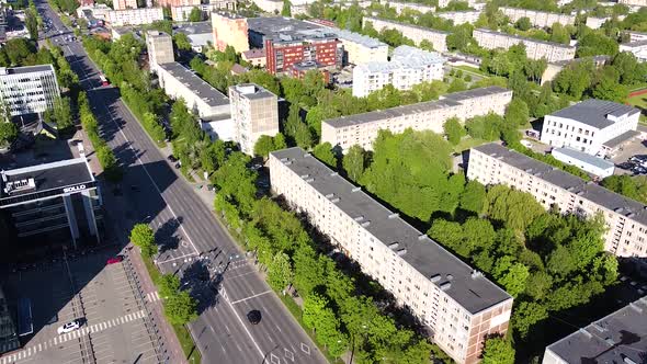 Savanoriai street and apartment buildings on sunny day in Kaunas, aerial