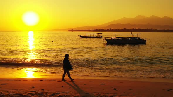 Young fun woman relaxing having fun on the beach on paradise white sand and blue 4K background