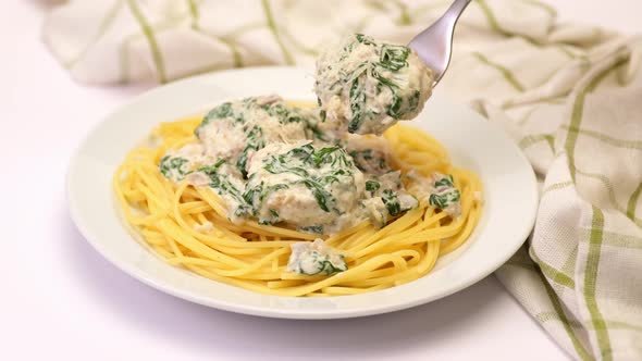 Portion of Delicious Meatballs with Spinach in a Creamy Sauce