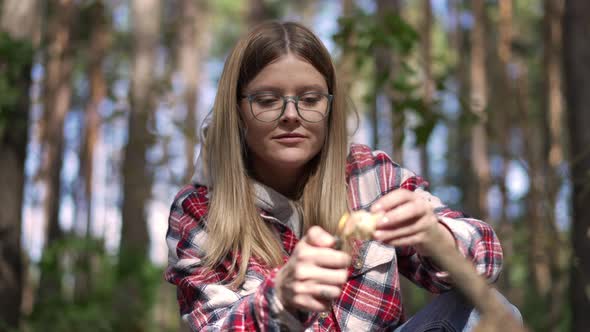 Portrait of Young Woman Igniting Lighter Setting Fire in Sunny Forest Outdoors