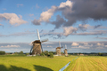 Windmills under great clouds in rural Holland - PhotoDune Item for Sale