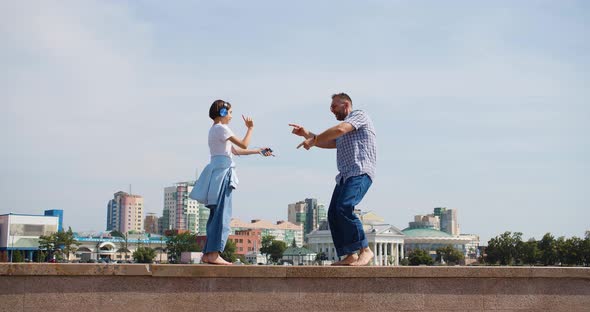 Father and Daughter are Dancing in the Street They are Celebrating the Beginning of the Summer