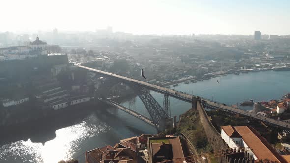 4k aerial footage of the steel bridge spanning across the river channel of coastal city of Porto