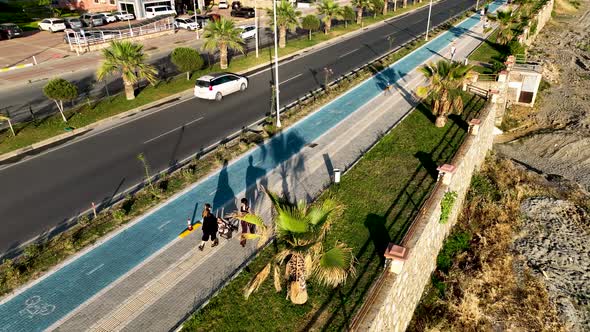 mama girls walks along the embankment aerial view 4 K